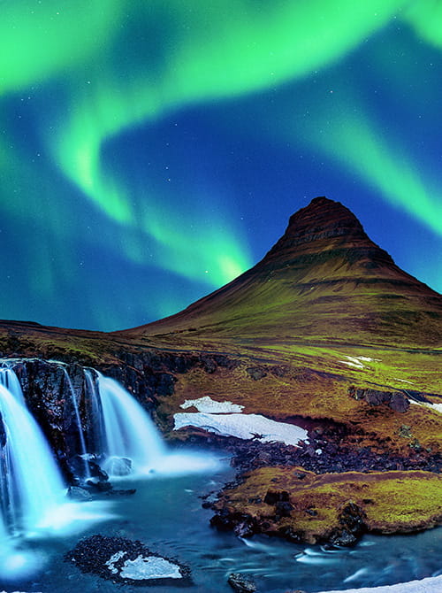 A stunning waterfall cascading down a majestic mountain, illuminated by the mesmerizing aurora lights.