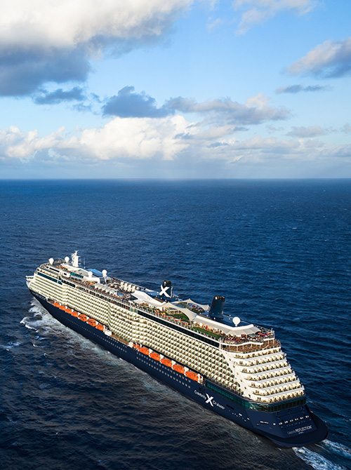 Aerial view of Celebrity Beyond cruise ship on open ocean at sunset