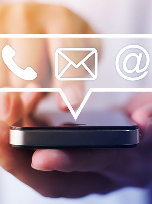 Close-up image of male hands using smartphone with icon telephone email mobile phone and address.